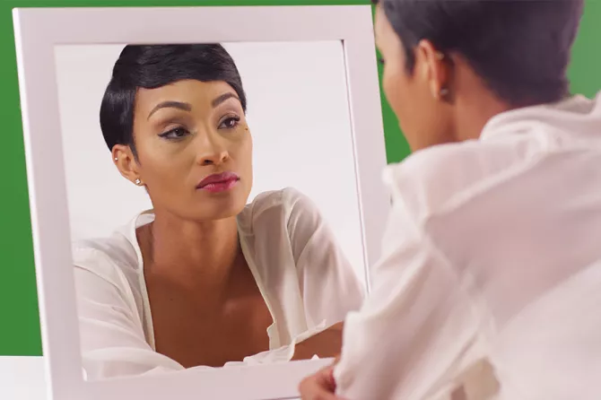 Woman staring in mirror