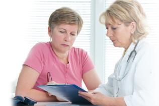 Woman having discussion with doctor