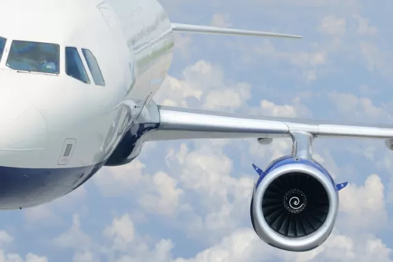 The left side of an Airbus A330 flying through a cloudy sky