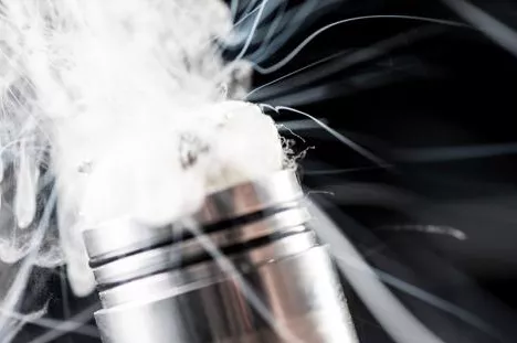Vapor comes out of the top of an electronic cigarette.