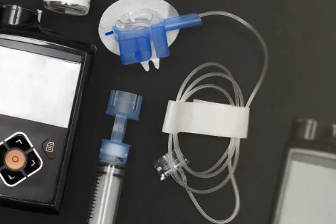 Overhead view of the components of an insulin pump and infusion set