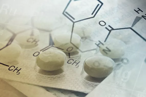 A graphic features a close-up of packaged pills overlaid with text indicating a chemical compound.