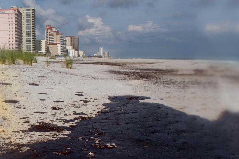 A blended image of a map and buildings along a beach that is polluted from an oil spill. 