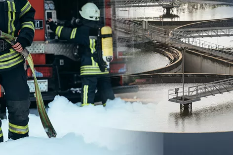 Two firefighters spraying white foam. The foam is seeping into a water treatment plant that appears to be part of a city water supply