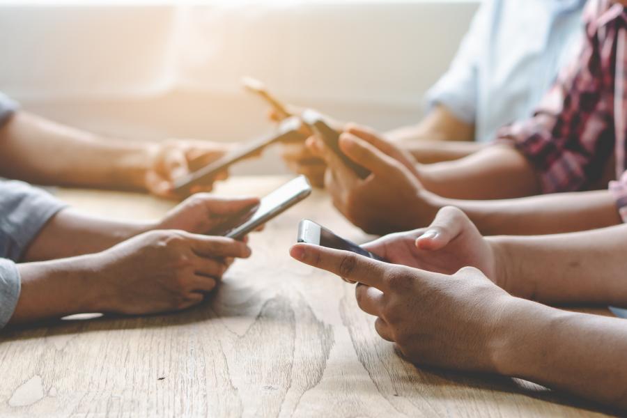 Teen hands holding cellphones