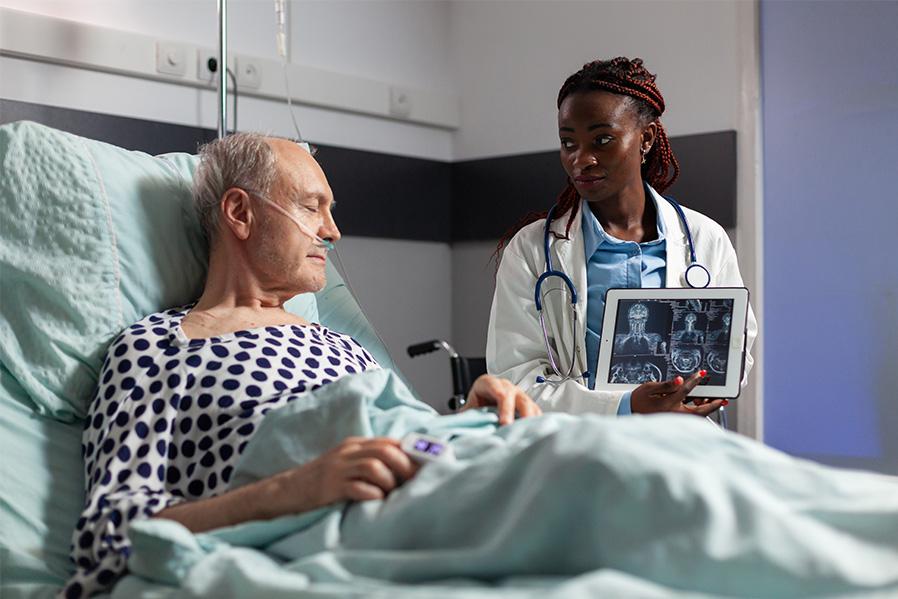 Patient in medical bed with Doctor visiting