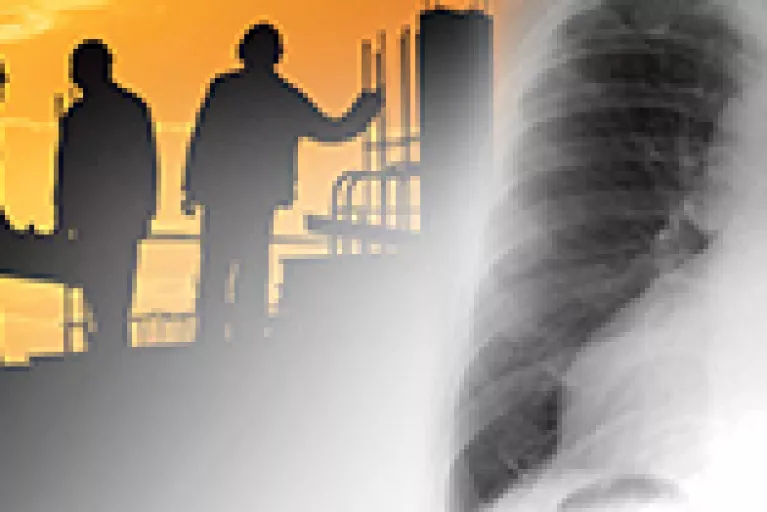 An image of a set of human lungs with a silhouetted image of workers in the background.